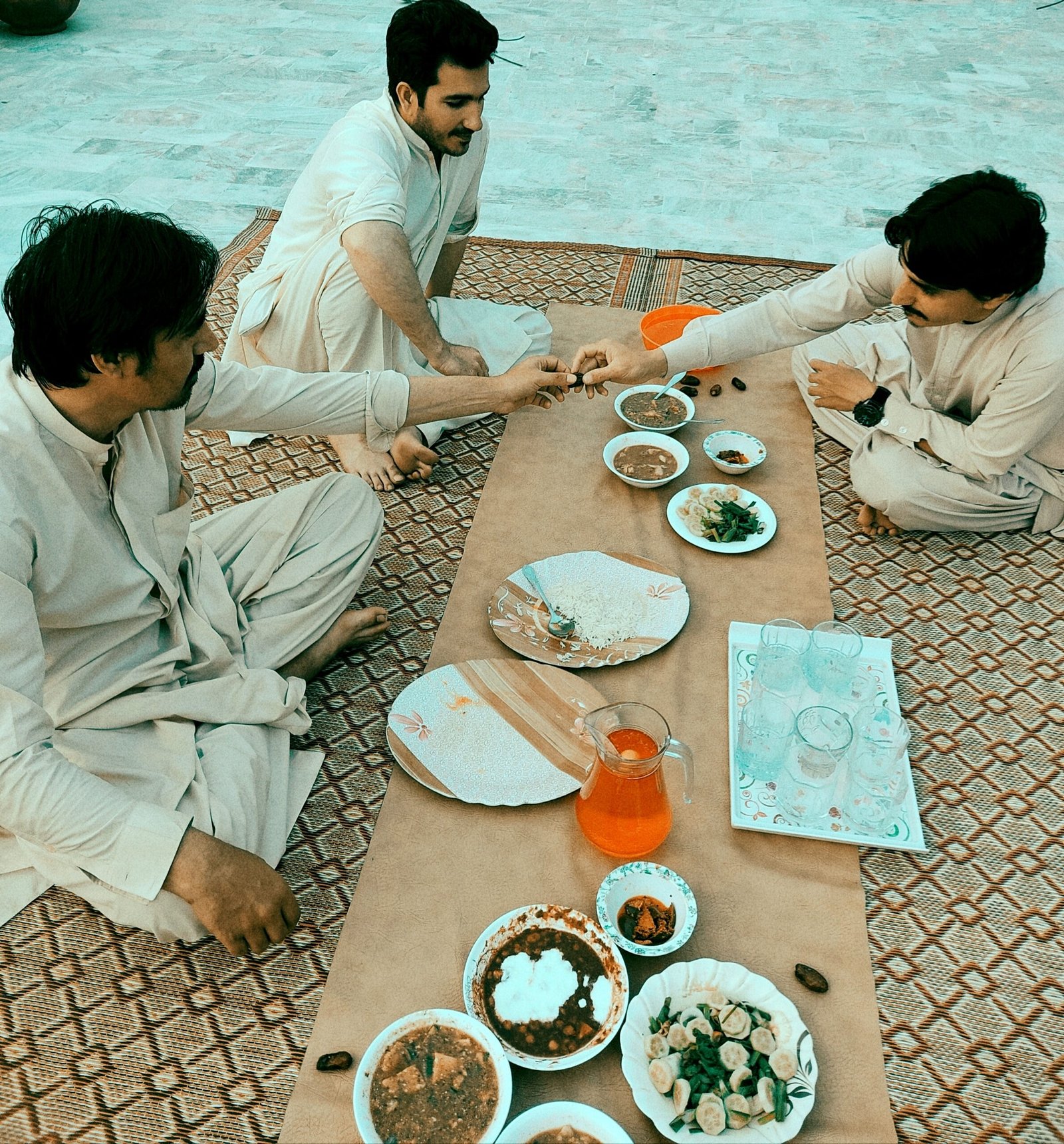 men-sharing-a-meal-together-outdoors-2026-01-07-06-27-44-utc